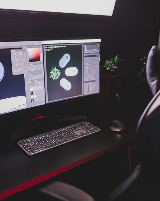 A stylish workspace featuring a laptop and monitors displaying design software.